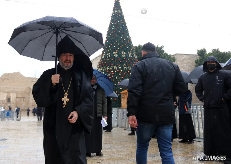 An Armenian monk walks in during the arrival of Armenian Patriarch of Jerusalem to the Church of the Nativity in the biblical West Bank city of Bethlehem on January 18, 2021, as the local Armenian community marks Christm...