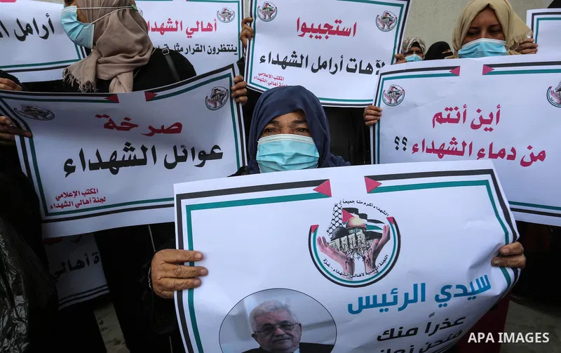 Palestinian families of martyrs and woundeds wearing protective face masks, take part in a protest to demand their rights and salaries, in Gaza city, on January 17, 2021.According to the main estimates between 2,125 and...