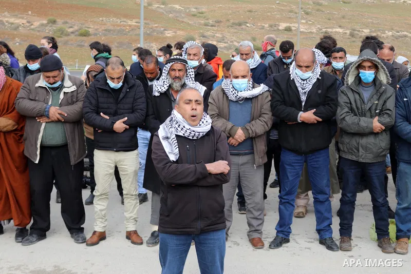 Palestinian protesters perform the Friday prayer during a protest against the Israeli army and settler attacks targeting the area’s Palestinian residents, in Yatta village in the southern West bank City of Hebron on Janu...