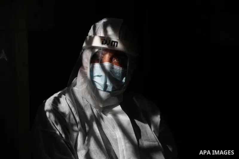 A Palestinian medical worker wearing protective gear, takes a random swab sample for COVID-19 testing inside a mosque, in Deir al-Balah, central of Gaza Strip, on January 11, 2021. The Palestinian Authority (PA) has said...