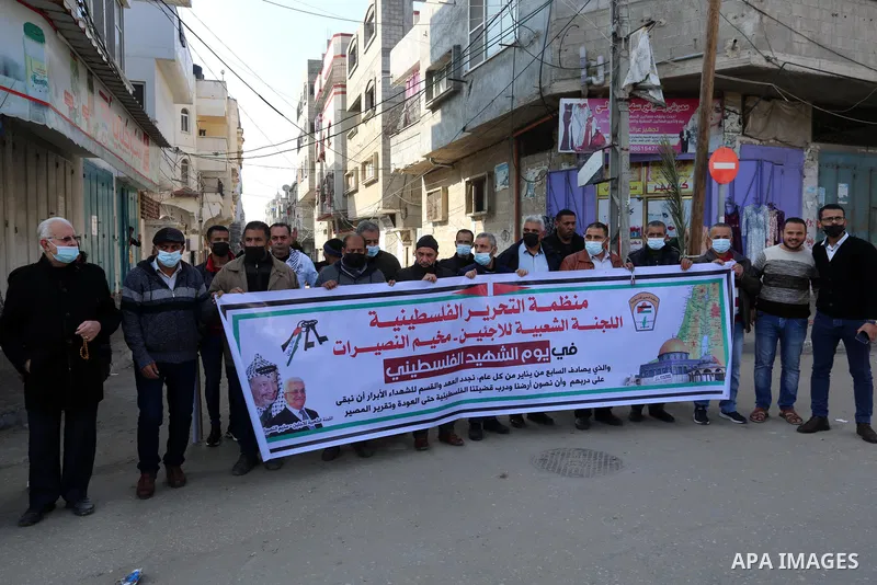 Palestinians carry banners with pictures of Palestinian martyrs, on the anniversary of the Palestinian martyr's day, in Nuseirat camp in the middle of the Gaza Strip, on January 7, 2020. In January 1965, Ahmad Musa, a Fe...
