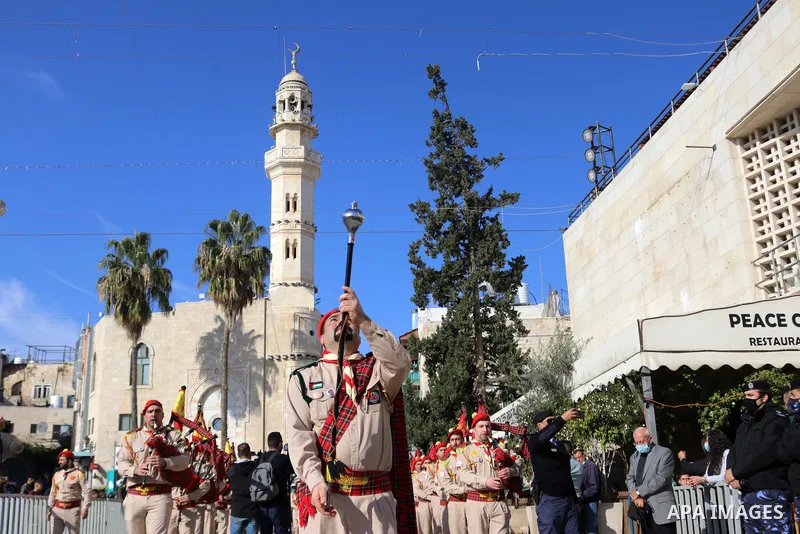 Palestinian scout bands perform as they parade during celebrations for Christmas, according to the Eastern Orthodox calendar, outside the Church of the Nativity in the West Bank city of Bethlehem, as Orthodox Christians...