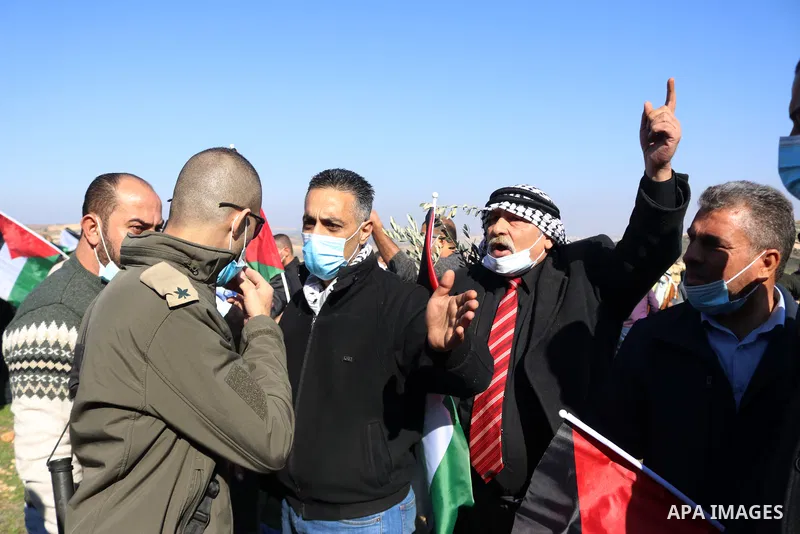 Israeli forces block Palestinians trying to reach their lands confiscated by Israeli authorities, during a protest in the village of Halhul, north of Hebron in the West Bank, on January 4, 2021. Israeli forces have preve...