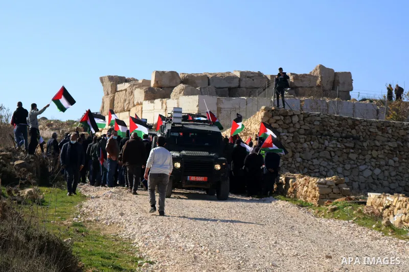 Israeli forces block Palestinians trying to reach their lands confiscated by Israeli authorities, during a protest in the village of Halhul, north of Hebron in the West Bank, on January 4, 2021. Israeli forces have preve...