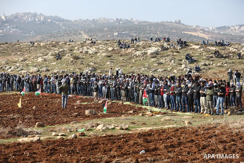 Palestinian protesters pray Friday prayers during a protest against Israeli settlements, in the West Bank village of Deir Jarir, north of Ramallah on January 1, 2021. Photo by Hamza Shalash/WAFA