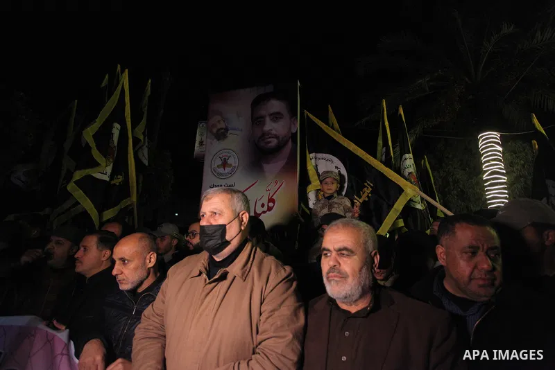 Palestinians hold placards during a protest in solidarity with hunger-striking Palestinian prisoner Hisham Abu Hawash, in Gaza city, to demand his release from Israeli detention without charges, as he teetered close to d...