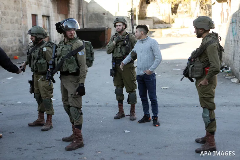 Palestinian protesters clash with Israeli troops in the West Bank city of Hebron on January 7, 2022. Photo by Mamoun Wazwaz