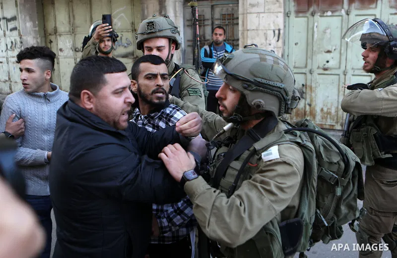 Palestinian protesters clash with Israeli troops in the West Bank city of Hebron on January 7, 2022. Photo by Mamoun Wazwaz