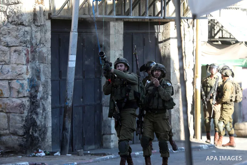 Palestinian protesters clash with Israeli troops in the West Bank city of Hebron on January 7, 2022. Photo by Mamoun Wazwaz