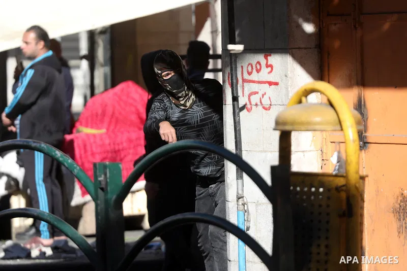Palestinian protesters clash with Israeli troops in the West Bank city of Hebron on January 7, 2022. Photo by Mamoun Wazwaz