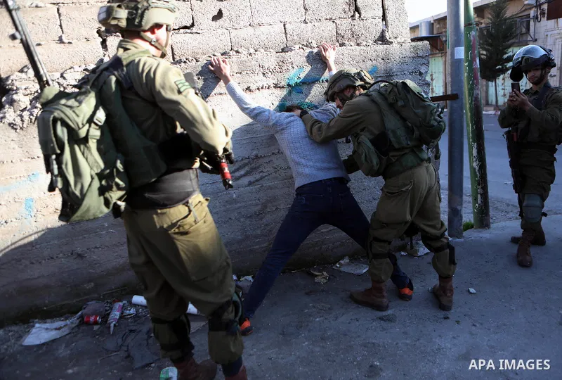 Palestinian protesters clash with Israeli troops in the West Bank city of Hebron on January 7, 2022. Photo by Mamoun Wazwaz