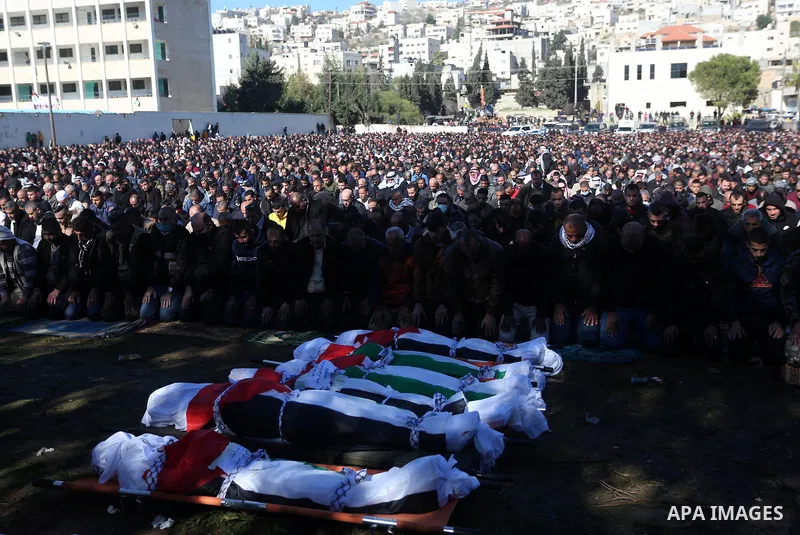 Palestinians attend the funeral of 8 workers who died a day earlier in a traffic accident while working in the Jordan Valley, on January 7, 2022, in the village of Aqraba, east of the West Bank city of Nablus. The worker...