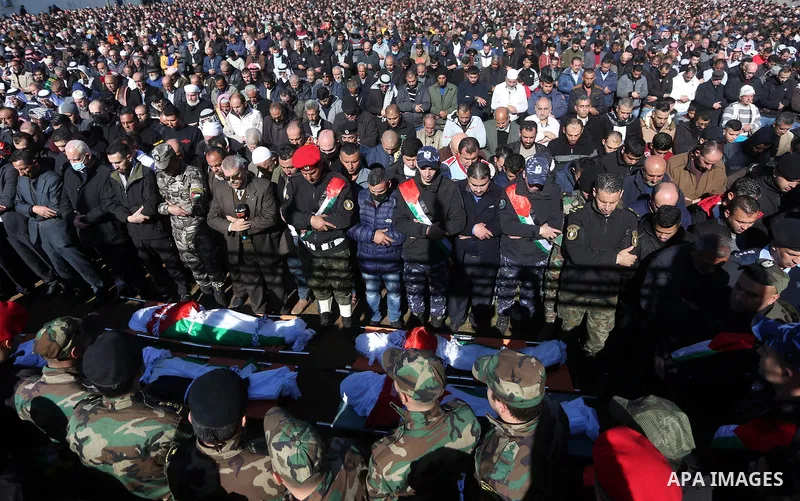 Palestinians attend the funeral of 8 workers who died a day earlier in a traffic accident while working in the Jordan Valley, on January 7, 2022, in the village of Aqraba, east of the West Bank city of Nablus. The worker...