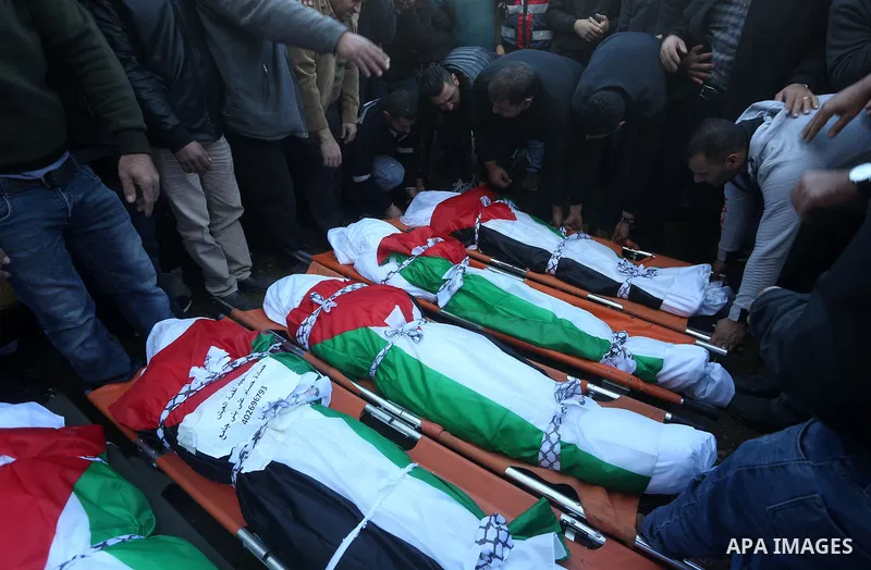 Palestinians attend the funeral of 8 workers who died a day earlier in a traffic accident while working in the Jordan Valley, on January 7, 2022, in the village of Aqraba, east of the West Bank city of Nablus. The worker...