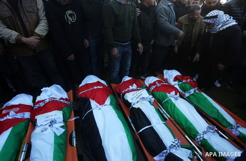 Palestinians attend the funeral of 8 workers who died a day earlier in a traffic accident while working in the Jordan Valley, on January 7, 2022, in the village of Aqraba, east of the West Bank city of Nablus. The worker...