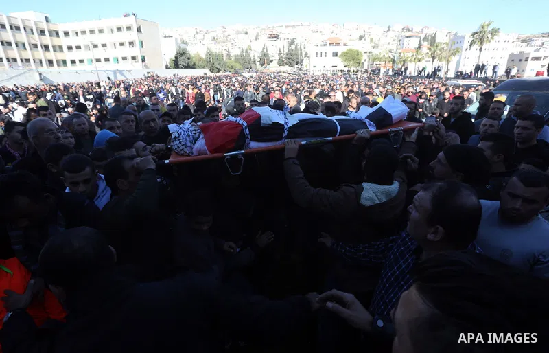 Palestinians attend the funeral of 8 workers who died a day earlier in a traffic accident while working in the Jordan Valley, on January 7, 2022, in the village of Aqraba, east of the West Bank city of Nablus. The worker...