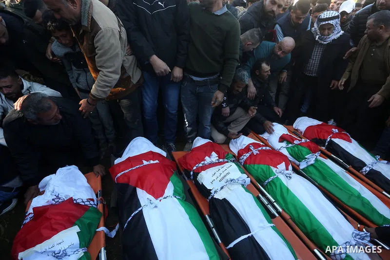 Palestinians attend the funeral of 8 workers who died a day earlier in a traffic accident while working in the Jordan Valley, on January 7, 2022, in the village of Aqraba, east of the West Bank city of Nablus. The worker...