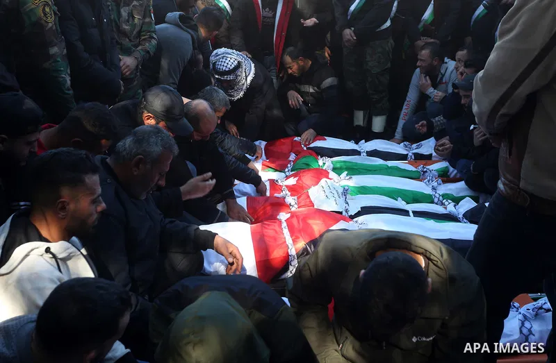 Palestinians attend the funeral of 8 workers who died a day earlier in a traffic accident while working in the Jordan Valley, on January 7, 2022, in the village of Aqraba, east of the West Bank city of Nablus. The worker...