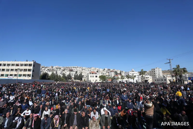 Palestinians attend the funeral of 8 workers who died a day earlier in a traffic accident while working in the Jordan Valley, on January 7, 2022, in the village of Aqraba, east of the West Bank city of Nablus. The worker...