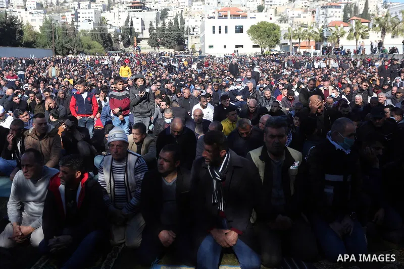 Palestinians attend the funeral of 8 workers who died a day earlier in a traffic accident while working in the Jordan Valley, on January 7, 2022, in the village of Aqraba, east of the West Bank city of Nablus. The worker...