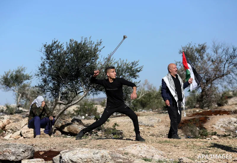 Palestinian protesters clash with Israeli security forces following a demonstration against settlements in the village of Beita in the West Bank, on January 7, 2022. Photo by Wajed Nobani