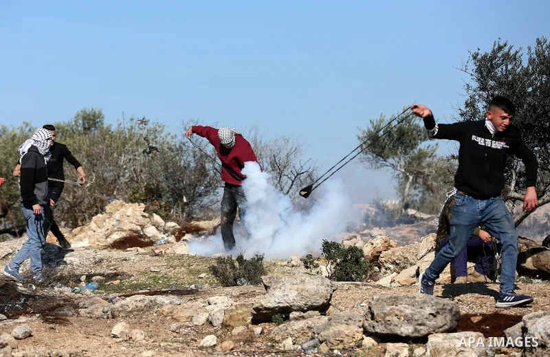 Palestinian protesters clash with Israeli security forces following a demonstration against settlements in the village of Beita in the West Bank, on January 7, 2022. Photo by Wajed Nobani