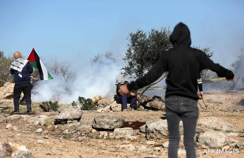 Palestinian protesters clash with Israeli security forces following a demonstration against settlements in the village of Beita in the West Bank, on January 7, 2022. Photo by Wajed Nobani