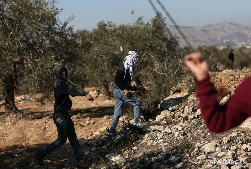 Palestinian protesters clash with Israeli security forces following a demonstration against settlements in the village of Beita in the West Bank, on January 7, 2022. Photo by Wajed Nobani