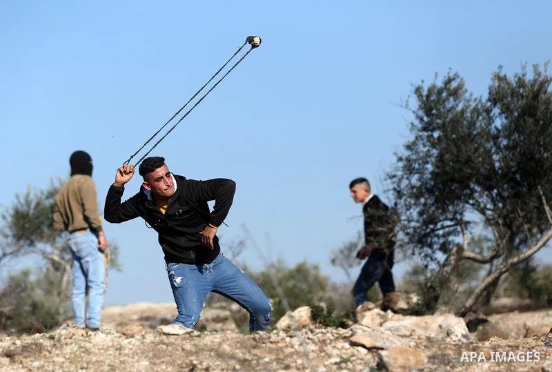 Palestinian protesters clash with Israeli security forces following a demonstration against settlements in the village of Beita in the West Bank, on January 7, 2022. Photo by Wajed Nobani