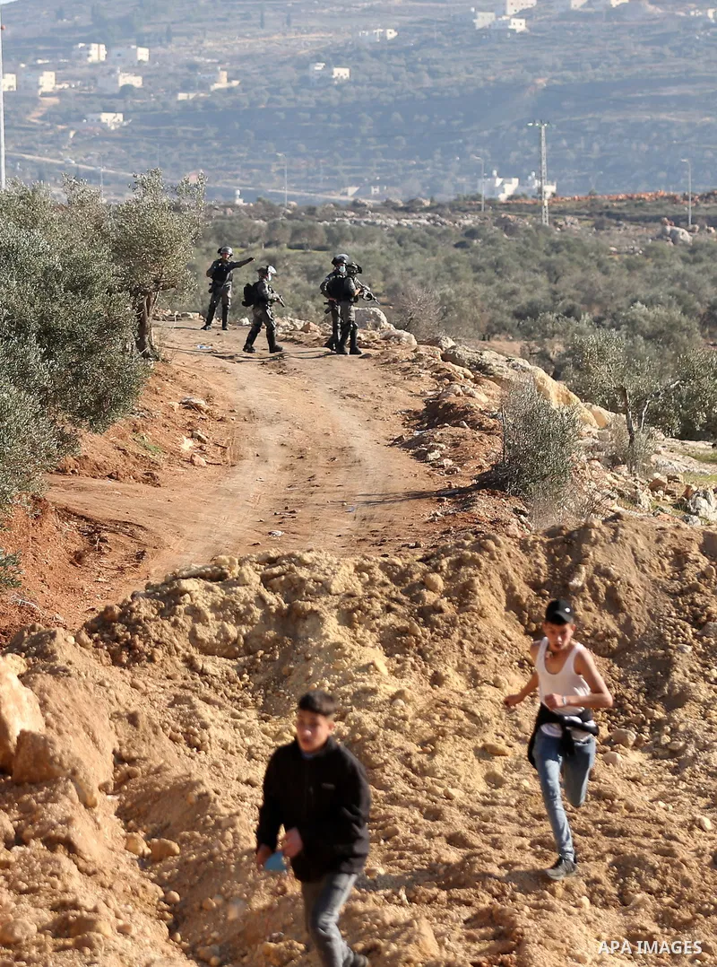 Palestinian protesters clash with Israeli security forces following a demonstration against settlements in the village of Beita in the West Bank, on January 7, 2022. Photo by Wajed Nobani