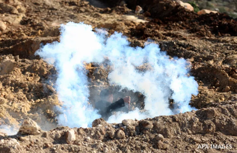 Palestinian protesters clash with Israeli security forces following a demonstration against settlements in the village of Beita in the West Bank, on January 7, 2022. Photo by Wajed Nobani