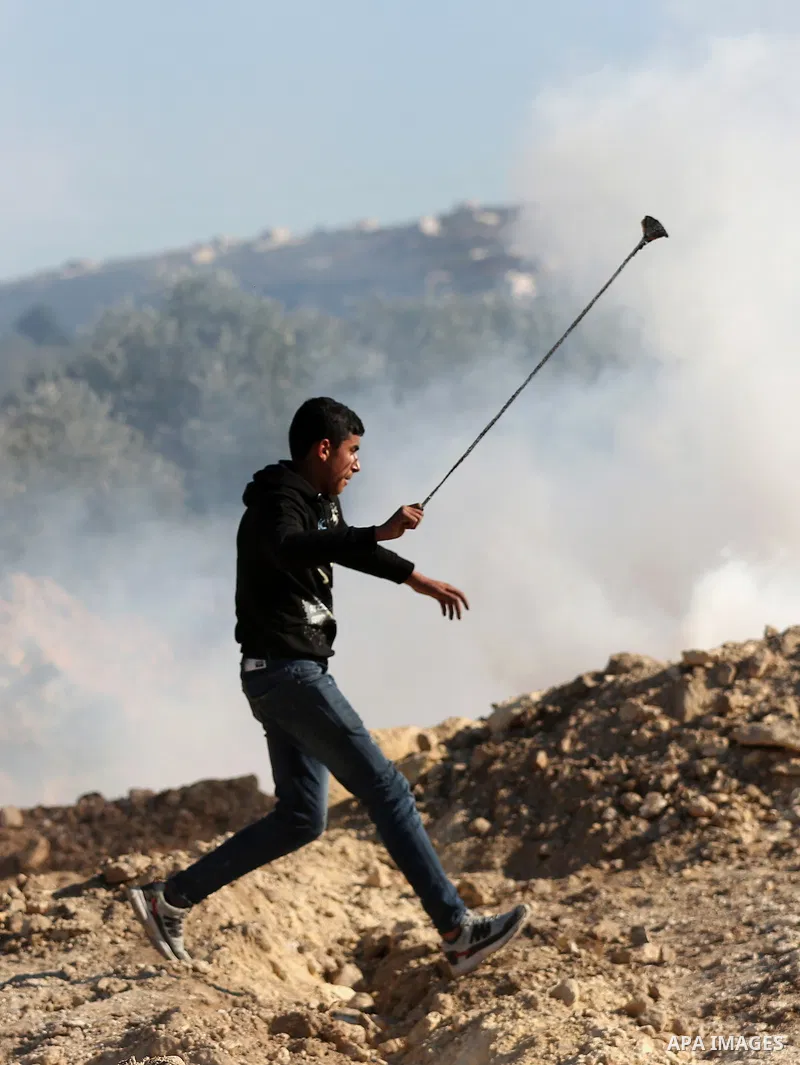 Palestinian protesters clash with Israeli security forces following a demonstration against settlements in the village of Beita in the West Bank, on January 7, 2022. Photo by Wajed Nobani