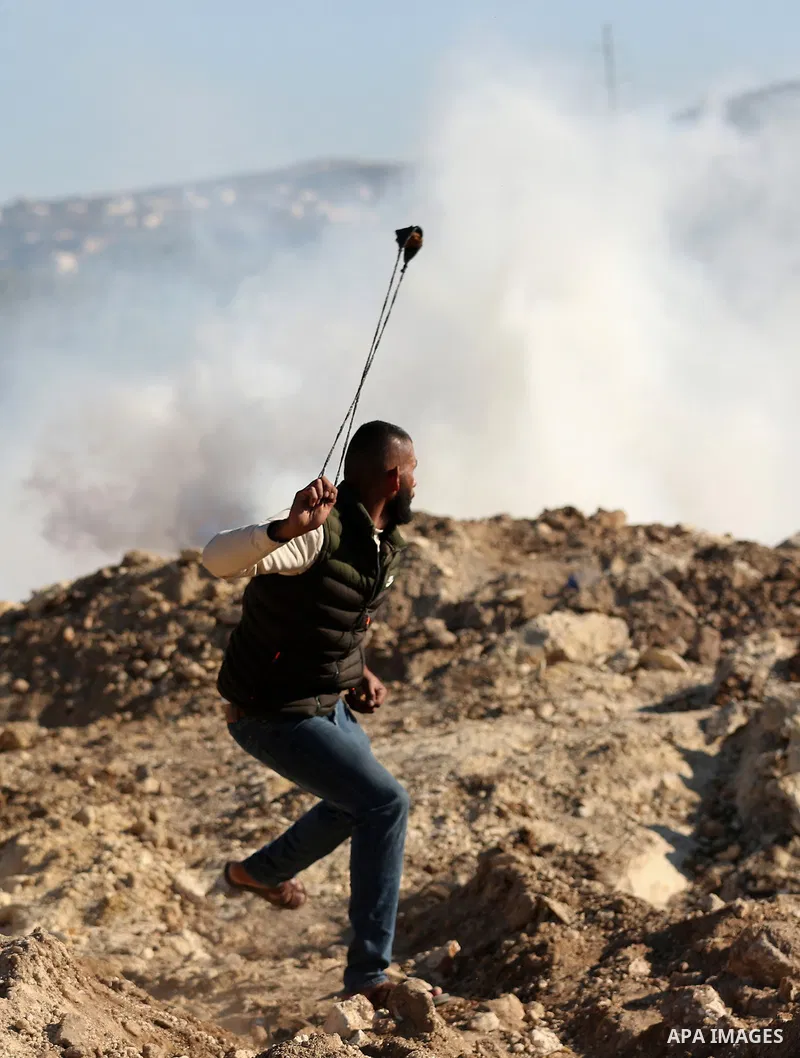 Palestinian protesters clash with Israeli security forces following a demonstration against settlements in the village of Beita in the West Bank, on January 7, 2022. Photo by Wajed Nobani