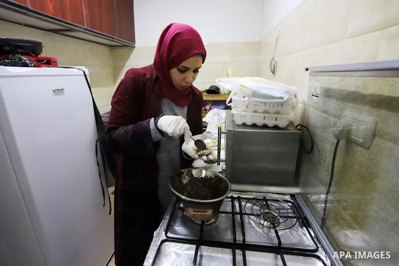 Palestinian chef Hana Al-Wakeel cooks healthy food at healthy home store ​in Gaza city on January 11, 2022. Al-Wakeel cooks healthy food by using healthy materials for low calories. She named the project (Healthy Home) t...