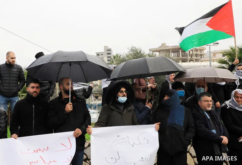 People shout slogans and wave Palestinian national flags during a protest in the mostly Arab city of Umm al-Fahm in northern Israel in solidarity with Bedouin communites in the Negev Desert against an afforestation proje...