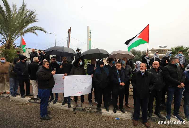 People shout slogans and wave Palestinian national flags during a protest in the mostly Arab city of Umm al-Fahm in northern Israel in solidarity with Bedouin communites in the Negev Desert against an afforestation proje...