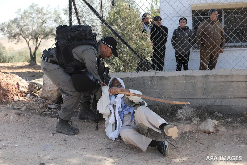 (FILE) A photo taken on December 06, 2021. A Palestinian Sheikh Suleiman Al-Hathlin confronts Israeli soldiers during the demolition of his house located under the pretext of building without a permit in Yatta south of H...