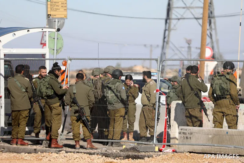 Israeli forces gather at a scene where a Palestinian man shot dead after allegedly attempting to carry out a stabbing attack at the Gush Etzion colonial settlement junction, south of Bethlehem, according to security sour...
