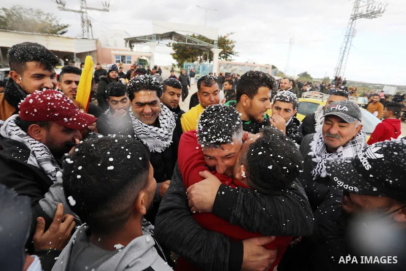 Palestinian freed prisoner Nashat Abu Rock, 41, greets his relatives after released following spend 5 year Israeli jails, in front of Erez crossing in Beit Hanoun in the northern Gaza Strip, on January 20, 2022. Photo by...
