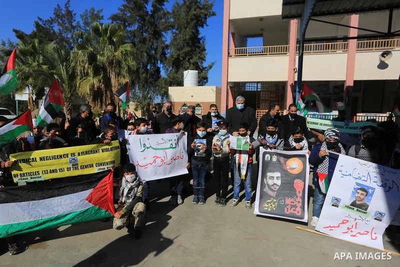 Palestinian students take part in a protest in solidarity with cancer patient's prisoner Nasser Abu Hamid, in Khan Younis in the southern of Gaza stripon January 25, 2022. Nasser Abu Hamid, 49, was moved from prison to I...