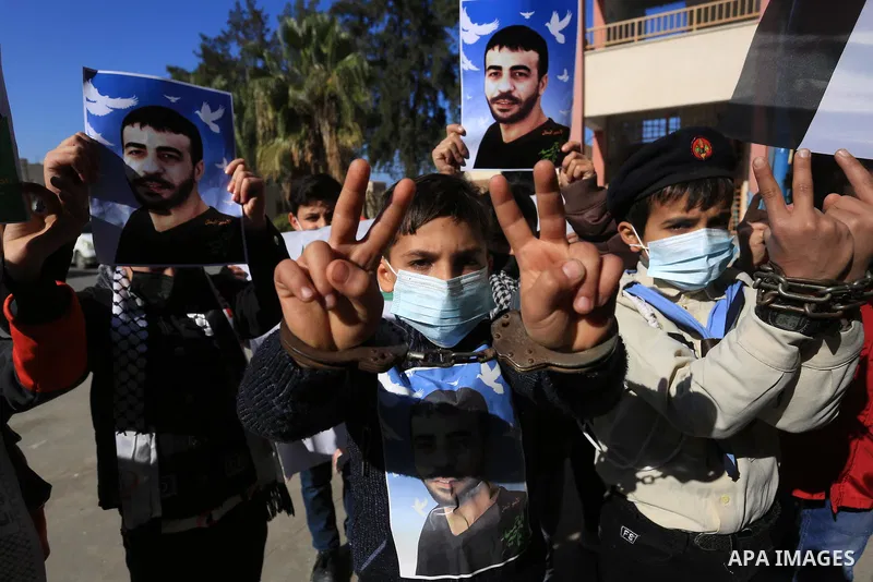 Palestinian students take part in a protest in solidarity with cancer patient's prisoner Nasser Abu Hamid, in Khan Younis in the southern of Gaza stripon January 25, 2022. Nasser Abu Hamid, 49, was moved from prison to I...