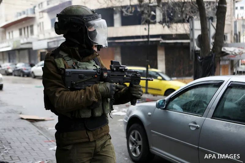 Israeli security forces take position during clashes with Palestinian protesters against settlements in the West Bank city of Hebron on January 28, 2022. Photo by Mamoun Wazwaz