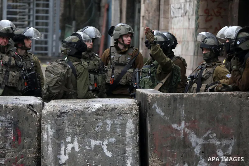 Israeli security forces take position during clashes with Palestinian protesters against settlements in the West Bank city of Hebron on January 28, 2022. Photo by Mamoun Wazwaz