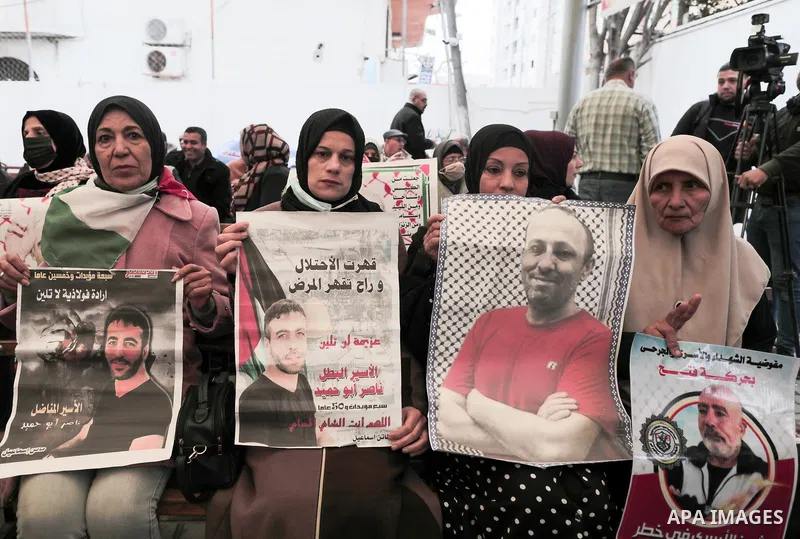 Palestinians take part in a protest in solidarity with prisoners in Israeli jails, in front of Red Cross office in Gaza city on January 31, 2022. Photo by Youssef Abu Watfa