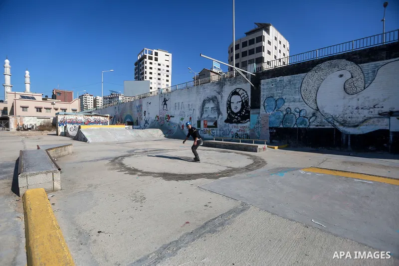 Palestinian youth Hani al-Hajjar, 21, performs moves during a skate roll training, in Gaza city on January 31, 2022. Al-Hajjar from Gaza City, started playing skateboard in early 2016 in the streets and alleys of Gaza Ci...