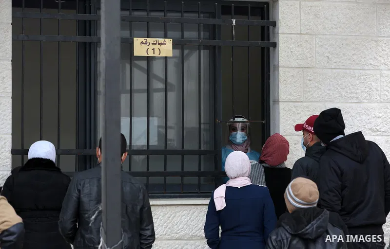 A medic from the Palestinian Health Ministry takes swab samples from people to test for the coronavirus, in the West Bank city of Nablus on January 31, 2022. Daily Covid-19 cases in Palestine continued to rise and reache...
