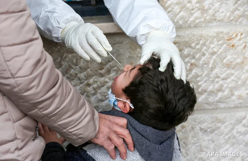 A medic from the Palestinian Health Ministry takes swab samples from people to test for the coronavirus, in the West Bank city of Nablus on January 31, 2022. Daily Covid-19 cases in Palestine continued to rise and reache...