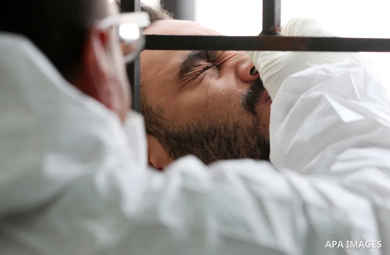 A medic from the Palestinian Health Ministry takes swab samples from people to test for the coronavirus, in the West Bank city of Nablus on January 31, 2022. Daily Covid-19 cases in Palestine continued to rise and reache...