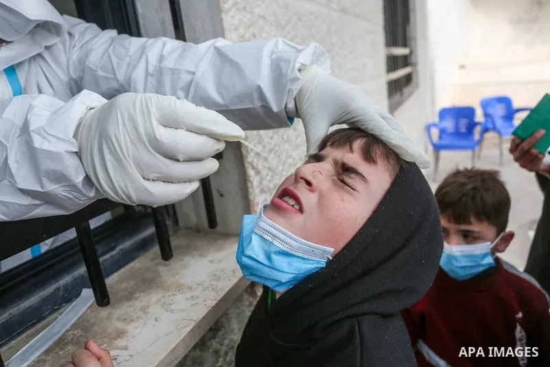 A medic from the Palestinian Health Ministry takes swab samples from people to test for the coronavirus, in the West Bank city of Nablus on January 31, 2022. Daily Covid-19 cases in Palestine continued to rise and reache...