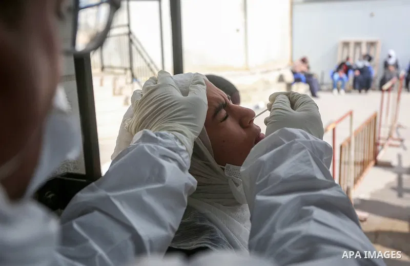 A medic from the Palestinian Health Ministry takes swab samples from people to test for the coronavirus, in the West Bank city of Nablus on January 31, 2022. Daily Covid-19 cases in Palestine continued to rise and reache...